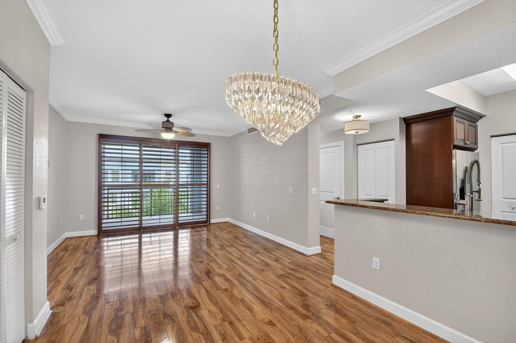 1660 Renaissance Commons Boulevard, Unit 2627 Boynton Beach, FL 33426 - Photo 2 of 32 a view of a kitchen with a dishwasher cabinets and wooden floor