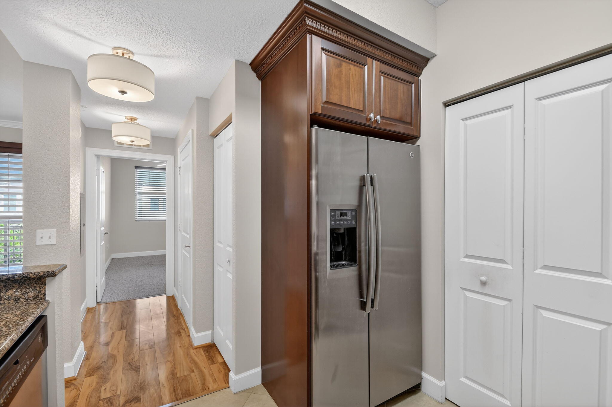 1660 Renaissance Commons Boulevard, Unit 2627 Boynton Beach, FL 33426 - Photo 5 of 32 a view of a hallway with wooden floor and staircase