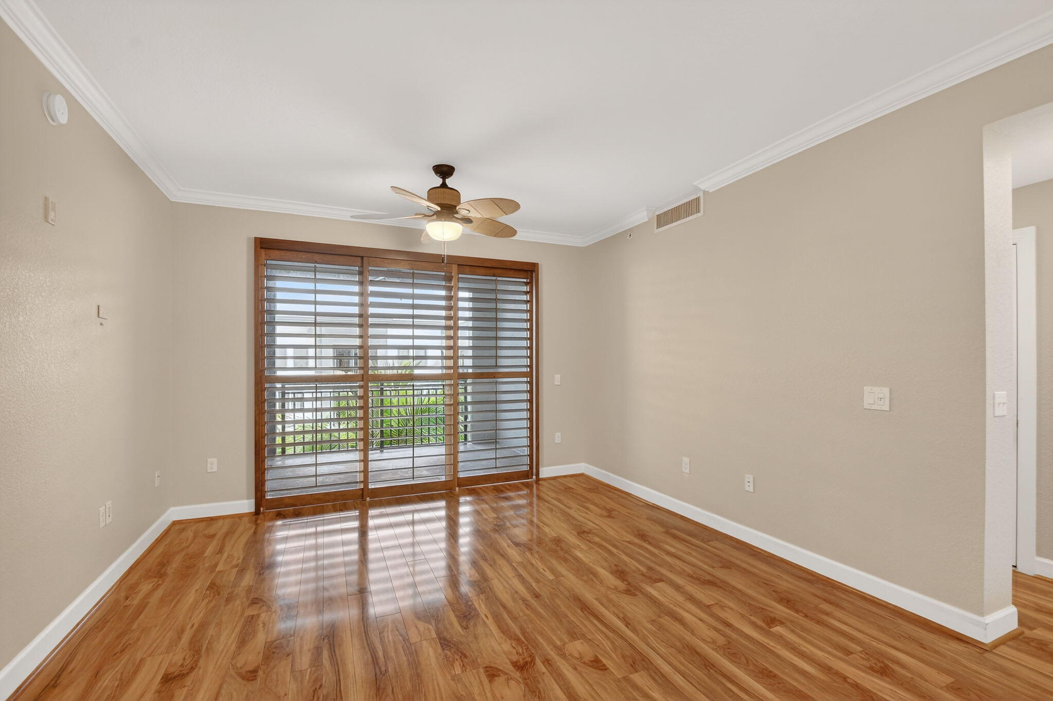 1660 Renaissance Commons Boulevard, Unit 2627 Boynton Beach, FL 33426 - Photo 6 of 32 a view of an empty room with wooden floor and a window