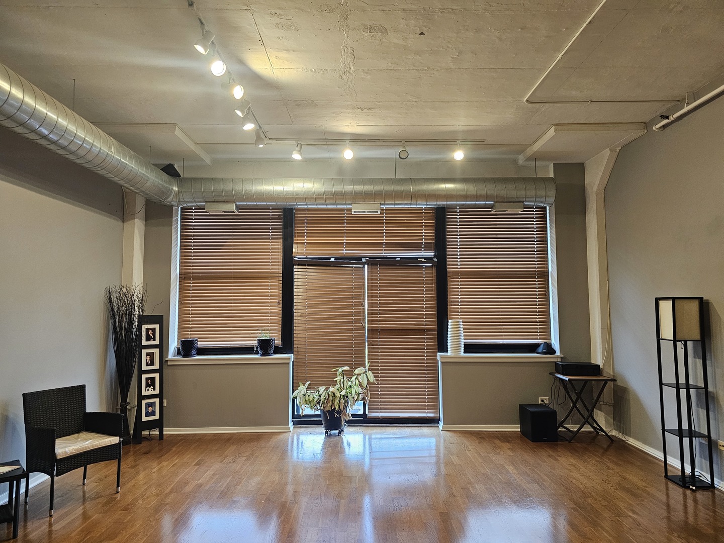 2323 West Pershing Road, Unit 230 Chicago, IL 60609 - Photo 6 of 30 a view of an empty room with wooden floor and a window
