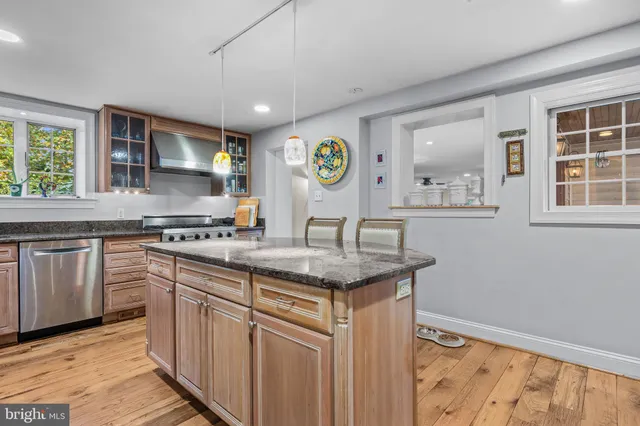 a view of a a dining room with furniture window and wooden floor