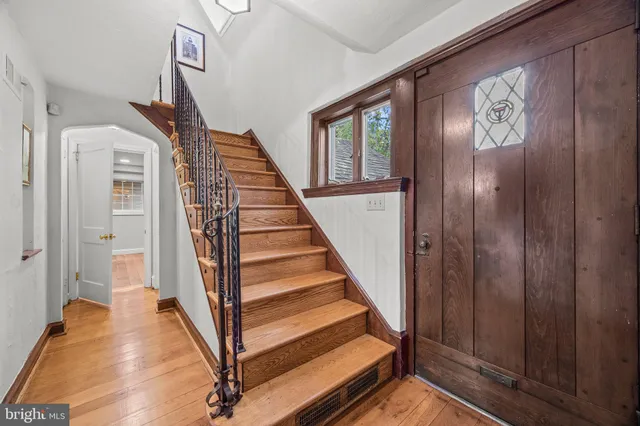 a room with furniture pool table flat screen tv and windows
