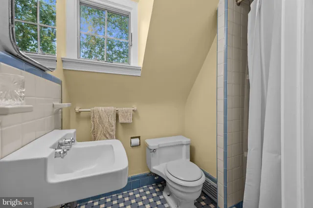 a spacious bathroom with a granite countertop sink and a mirror