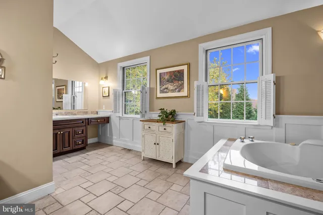 a view of a brick house with a large windows and a large tree