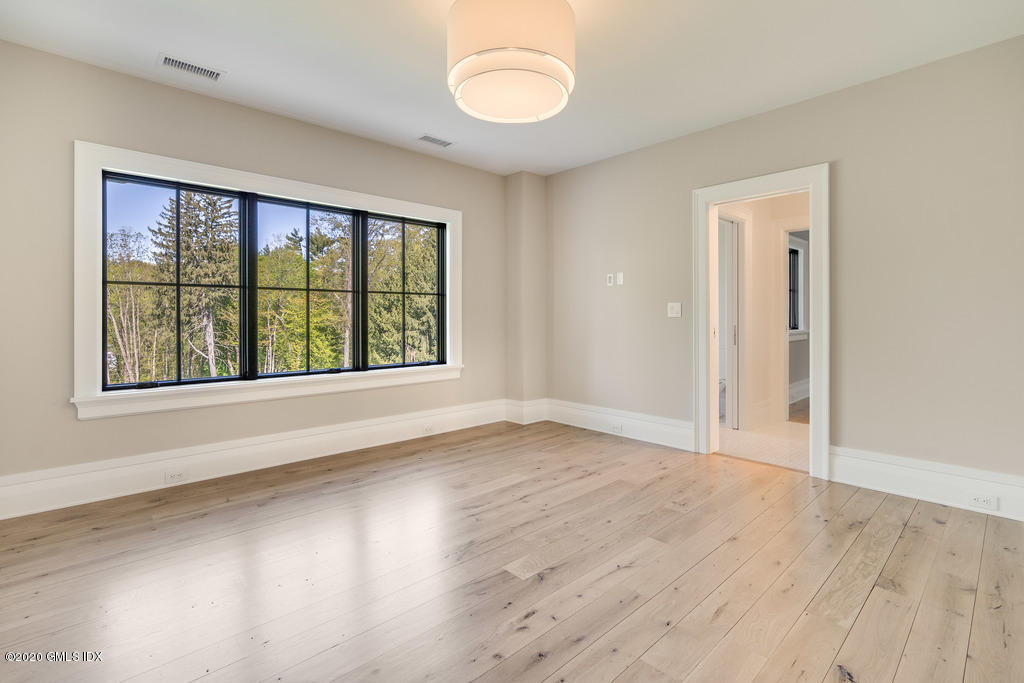 180 Stanwich Road Greenwich, CT 06830 - Photo 13 of 19 an empty room with wooden floor and windows