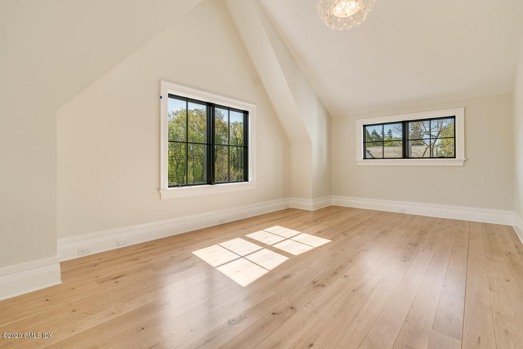 180 Stanwich Road Greenwich, CT 06830 - Photo 14 of 19 an empty room with wooden floor and windows