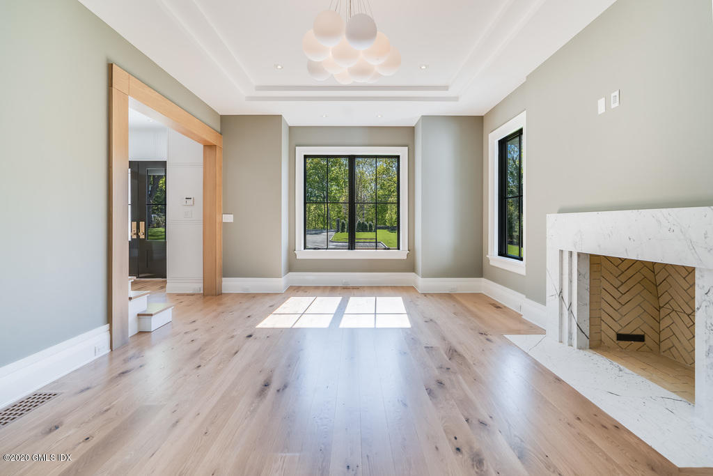 180 Stanwich Road Greenwich, CT 06830 - Photo 4 of 19 a view of an empty room with wooden floor and a window
