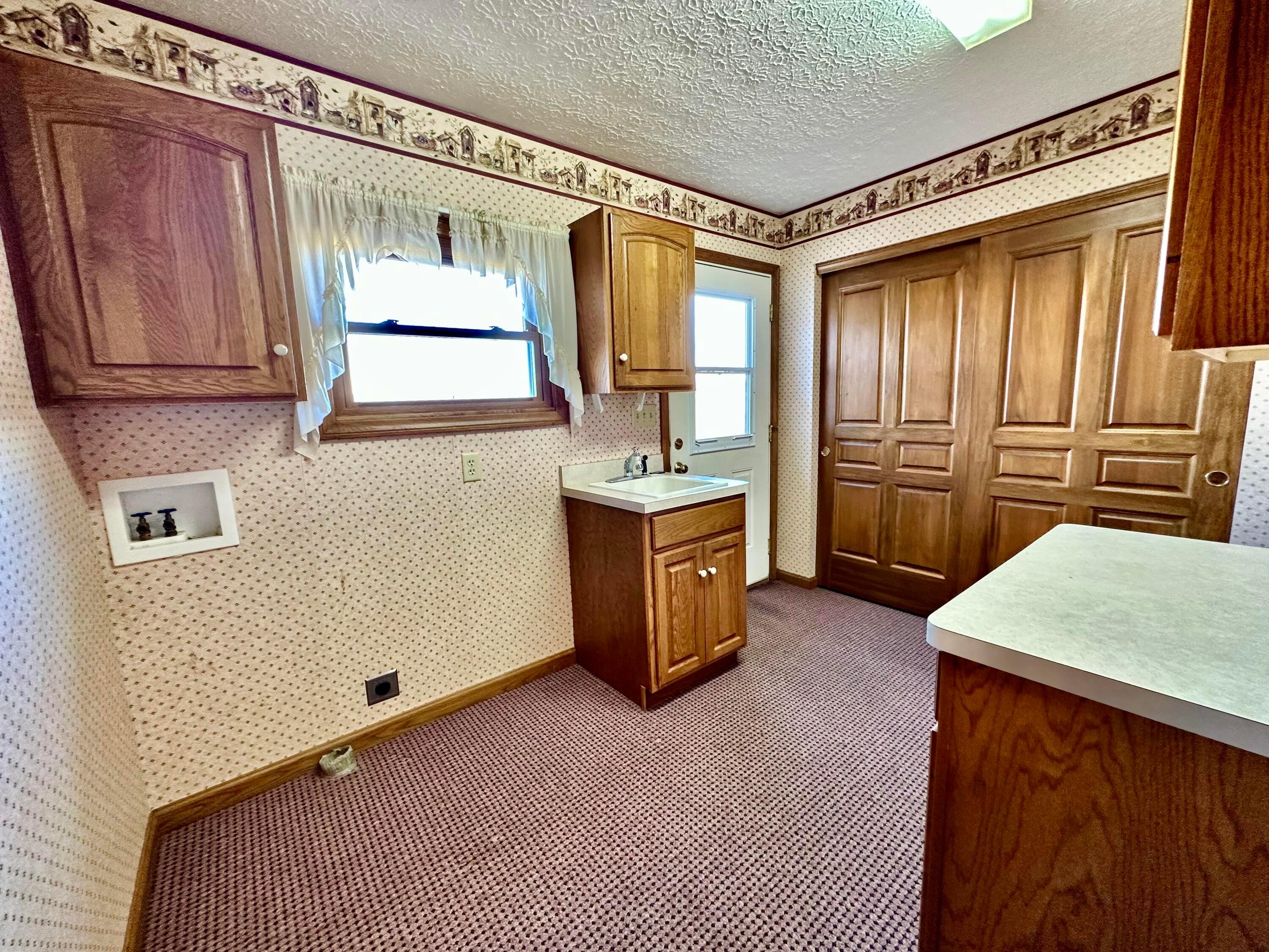 6189 Giehl Road Delaware, OH 43015 - Photo 31 of 70 Main level laundry with sink & storage closet.