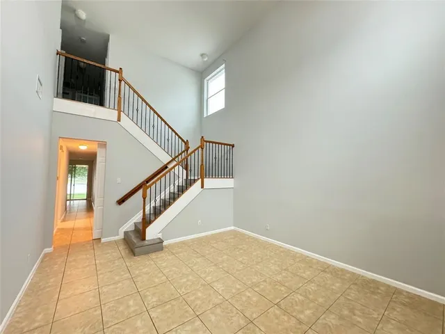 a view of staircase with white walls and railing