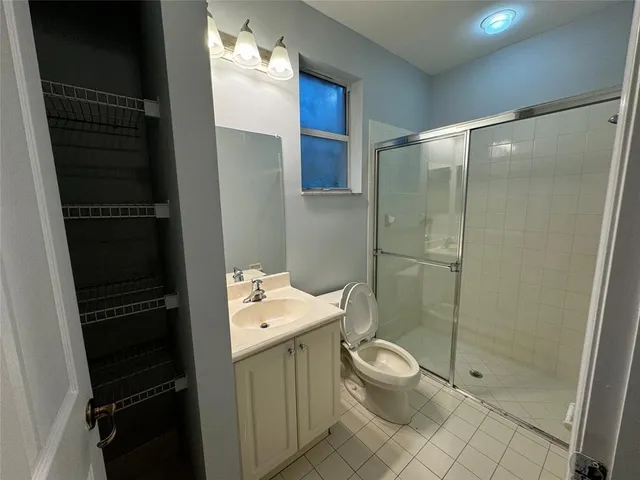 a bathroom with a toilet a sink and shower