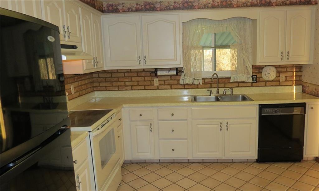 116 Julia Street Rices Landing, PA 15357 - Photo 11 of 25 CERAMIC FLOORS, BRICK BACK SPLASH... WHITE AND BRIGHT CABINETS!