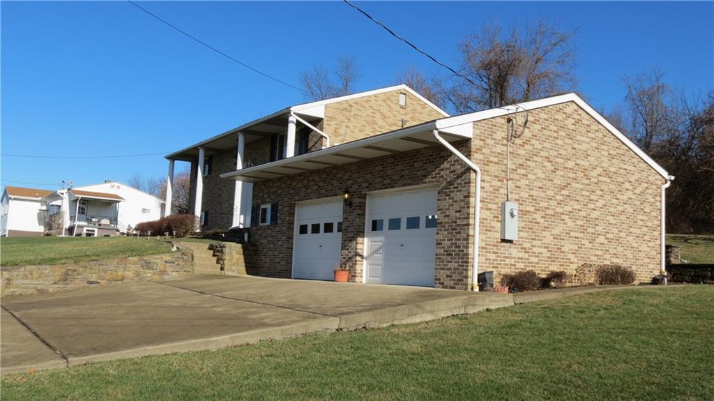 116 Julia Street Rices Landing, PA 15357 - Photo 22 of 25 STONE WALL IN FRONT, PLENTY OF ROOM - WIDE DRIVEWAY FOR GUESTS