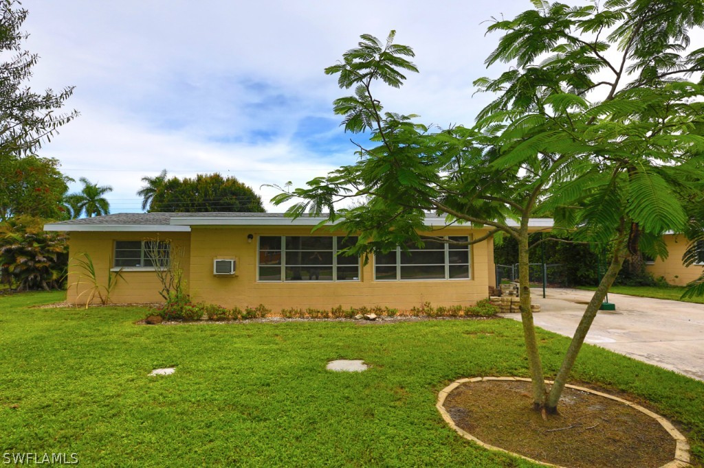 1450 Byron Road Fort Myers, FL 33919 - Photo 1 of 22 a backyard of a house with table and chairs