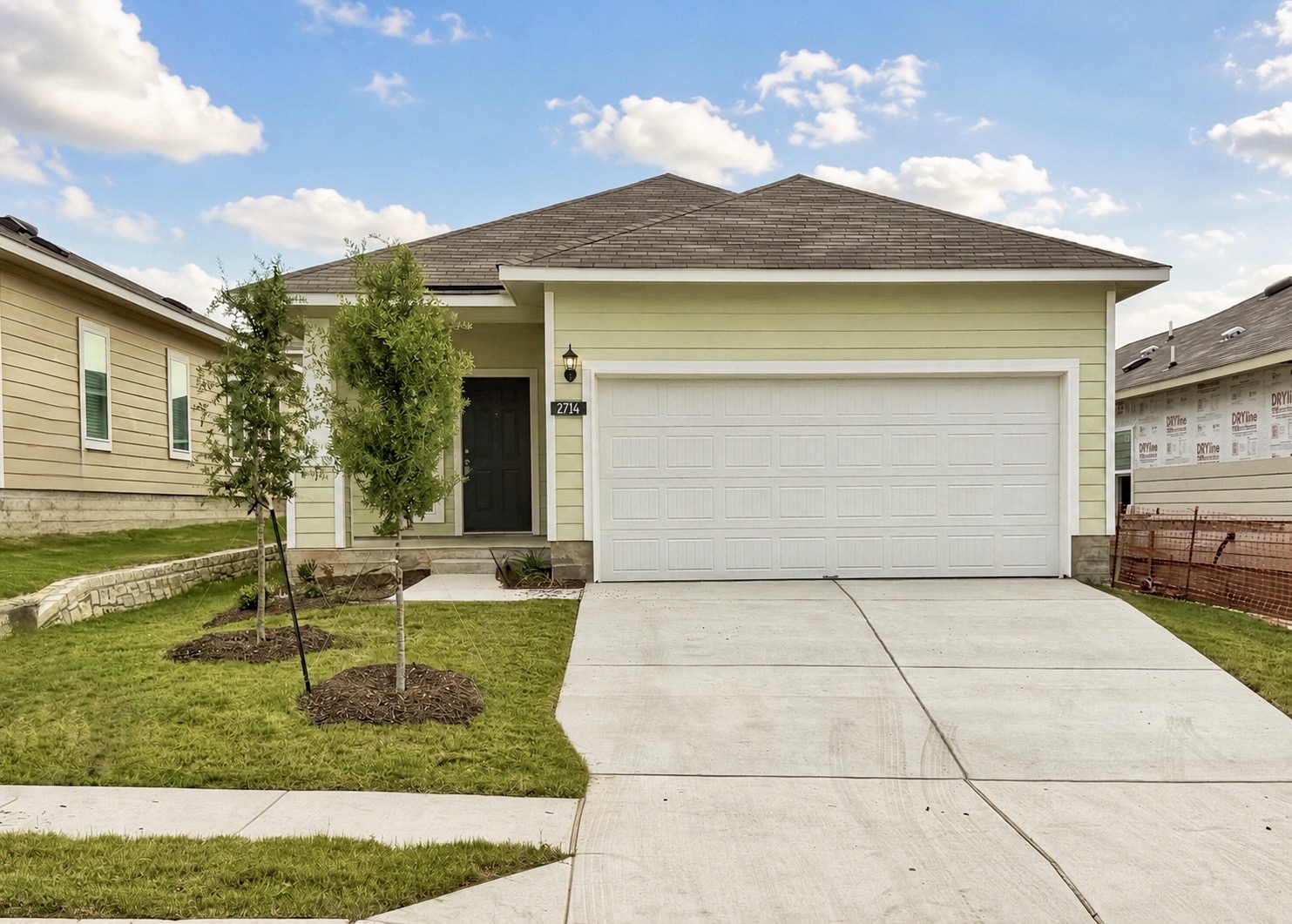 2714 Towy Road Manor, TX 78653 - Photo 2 of 22 A neatly manicured lawn frames this newly constructed home with an inviting front entry and attached garage.