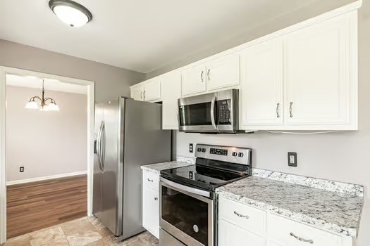 2029 Copper Kettle Circle Pleasant View, TN 37146 - Photo 25 of 58 a kitchen with stainless steel appliances granite countertop white cabinets and a granite counter tops