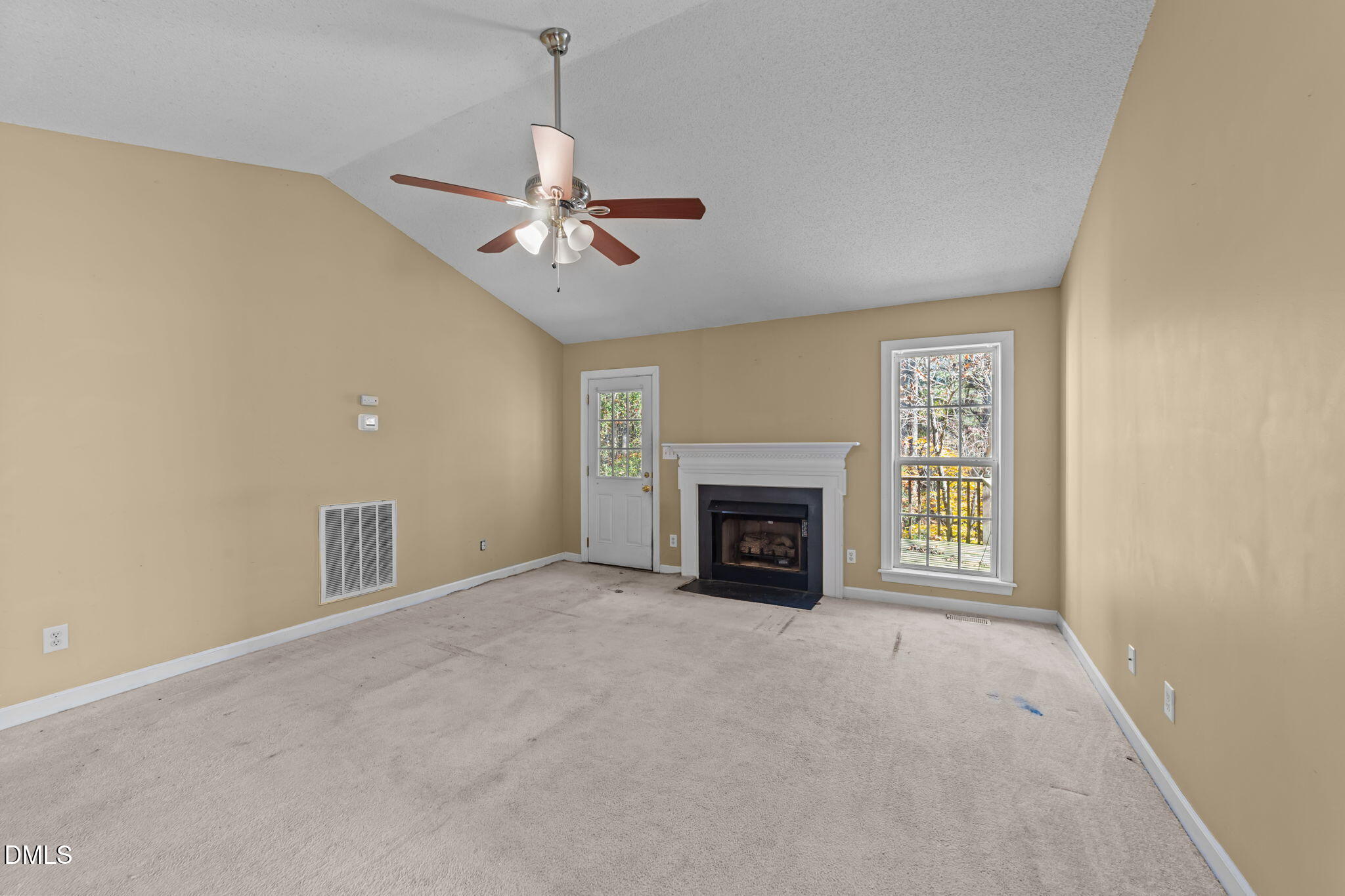624 Harris Point Way Wake Forest, NC 27587 - Photo 17 of 38 a view of an empty room with a fireplace and a window