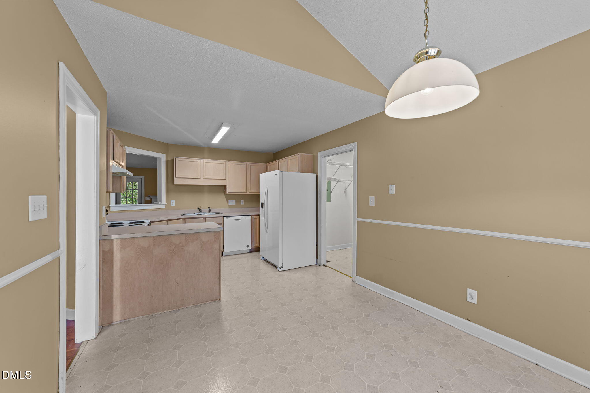 624 Harris Point Way Wake Forest, NC 27587 - Photo 9 of 38 a view of a kitchen with a sink wooden floor and a refrigerator