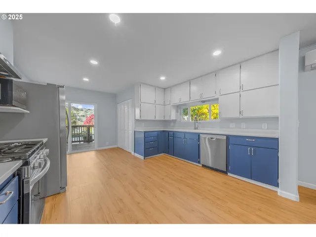 a kitchen with stainless steel appliances granite countertop a sink stove and cabinets