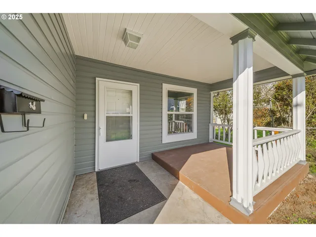 a view of a bedroom with wooden floor and windows