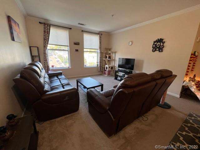 25 Adams Avenue, Unit 301 Stamford, CT 06902 - Photo 13 of 26 a living room with furniture and a flat screen tv