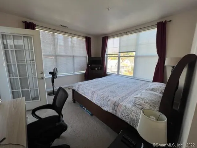 a bedroom with a bed and a desk