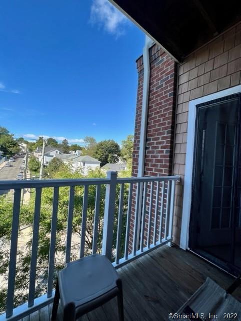25 Adams Avenue, Unit 301 Stamford, CT 06902 - Photo 20 of 26 a view of a balcony with chair and wooden floor
