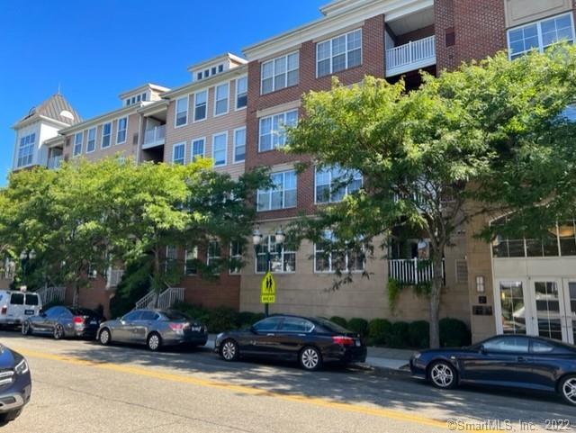 25 Adams Avenue, Unit 301 Stamford, CT 06902 - Photo 2 of 26 a car parked in front of a brick building