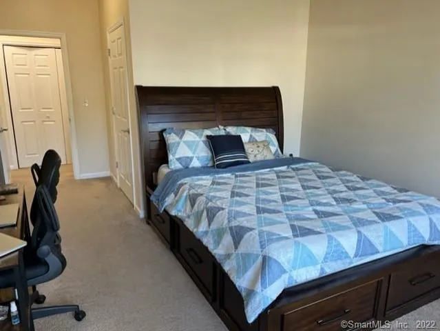 a bedroom with bed and a window