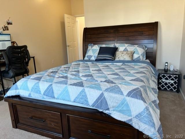 25 Adams Avenue, Unit 301 Stamford, CT 06902 - Photo 24 of 26 a bedroom with a bed and a dresser