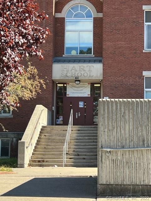 25 Adams Avenue, Unit 301 Stamford, CT 06902 - Photo 26 of 26 a view of a brick house with large windows