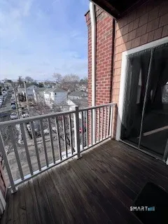 a view of a patio with a table and chairs under an umbrella