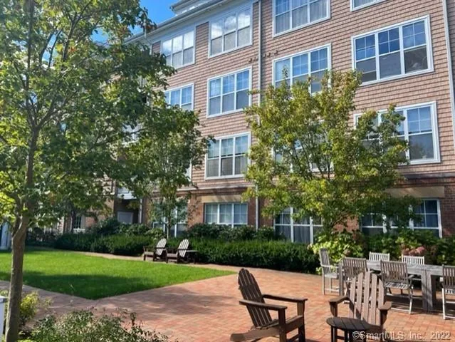a view of a brick house with large windows