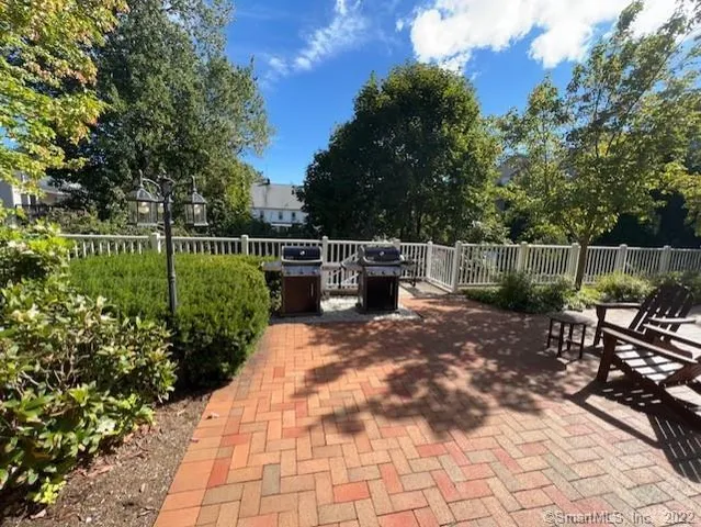 a view of a building with a yard and sitting area