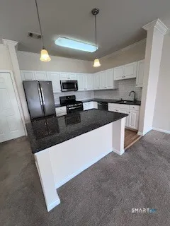 a kitchen with stainless steel appliances wooden cabinets and a stove top oven