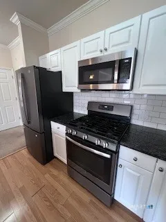 a kitchen with granite countertop a stove top oven a sink dishwasher and a microwave oven on the granite countertops