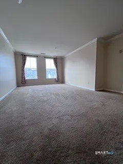 an empty room with windows and cabinet