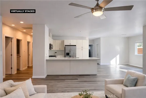 a living room with furniture and a wooden floor