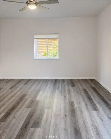 a view of an empty room and wooden floor