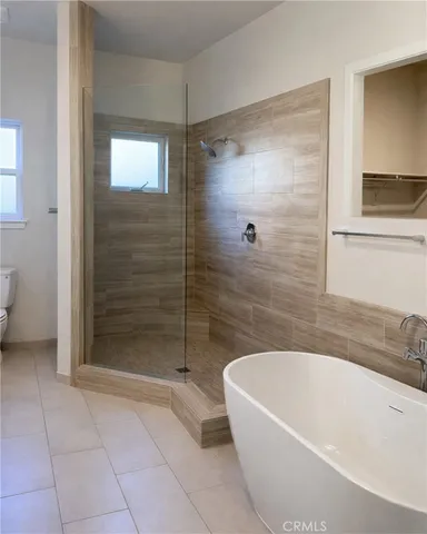 a bathroom with a bathtub and shower