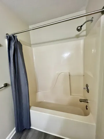 a bathroom with a shower and a bath tub