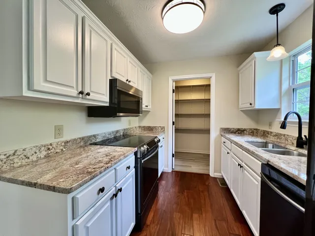 a kitchen with a stove a sink and a refrigerator