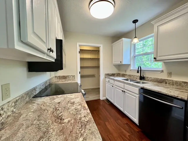 a kitchen with a sink stove and cabinets