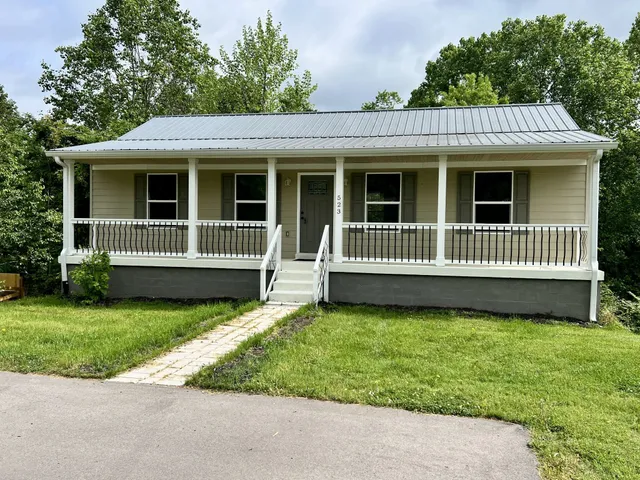 a front view of a house with a garden