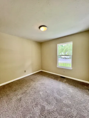 an empty room with a empty space and a window