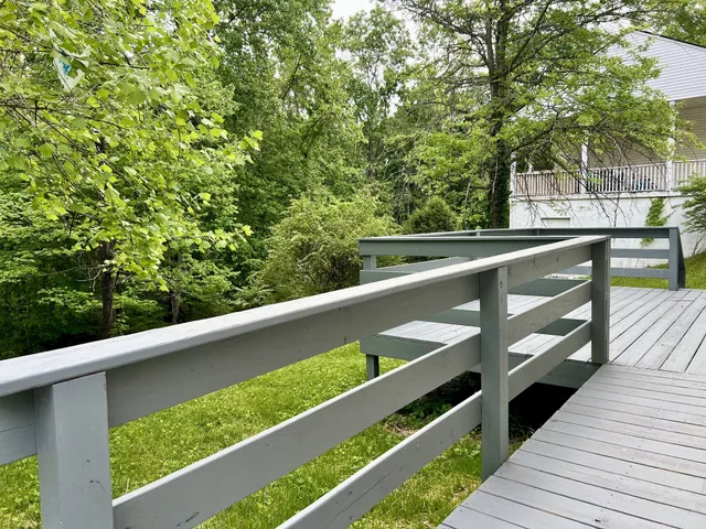 a view of balcony with wooden floor and fence