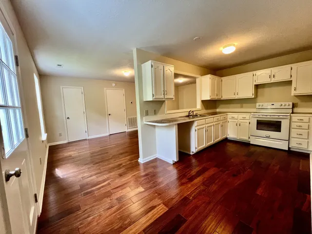 a kitchen with stainless steel appliances granite countertop a stove and a sink