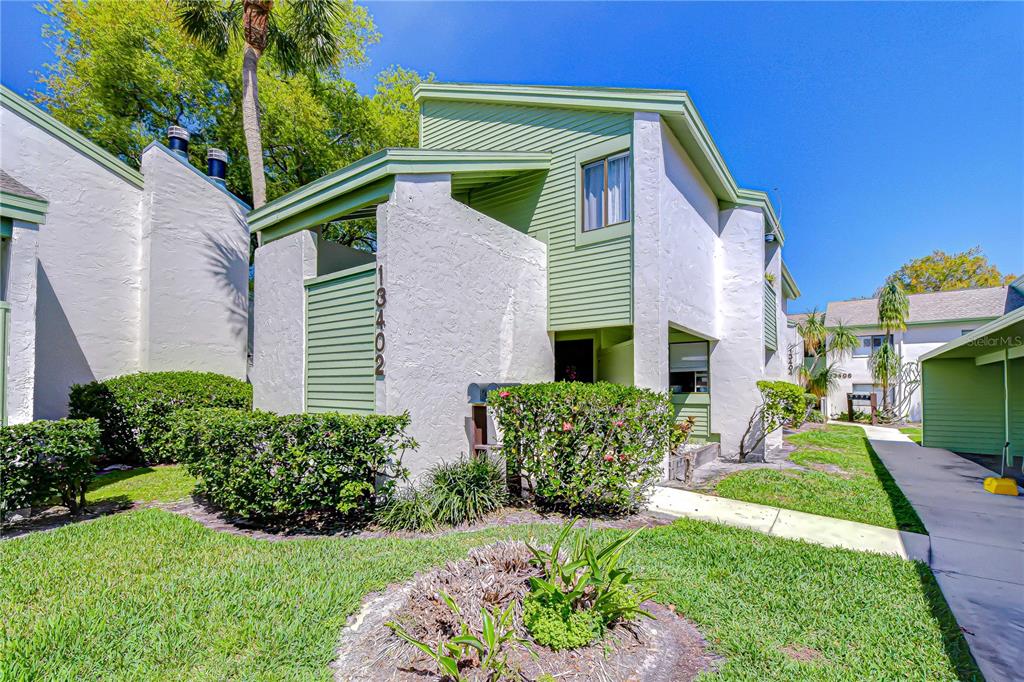 13402 Pinelake Way, Unit 202B Tampa, FL 33618 - Photo 1 of 42 a front view of a house with a yard