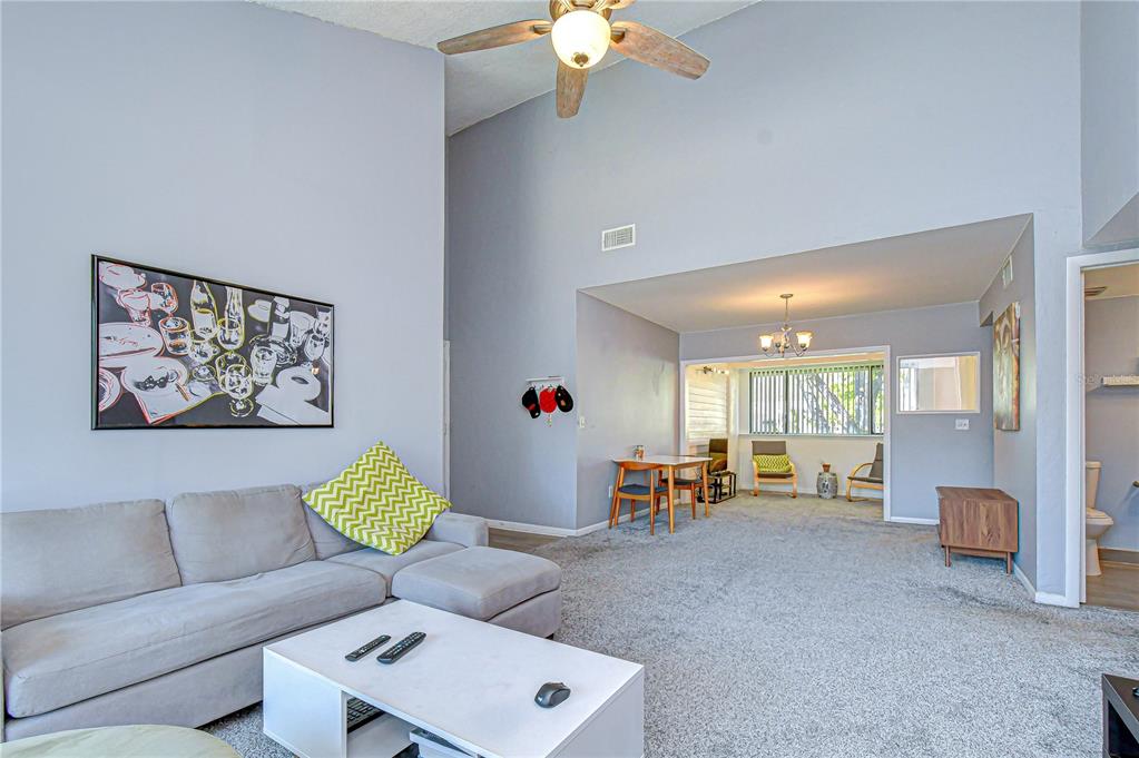 13402 Pinelake Way, Unit 202B Tampa, FL 33618 - Photo 11 of 42 a living room with furniture and a chandelier