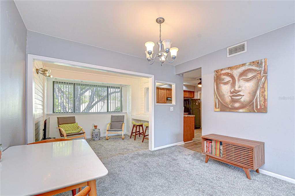 13402 Pinelake Way, Unit 202B Tampa, FL 33618 - Photo 15 of 42 a living room with furniture and a chandelier