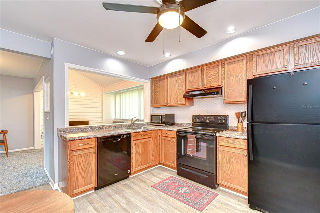 13402 Pinelake Way, Unit 202B Tampa, FL 33618 - Photo 21 of 42 a kitchen with stainless steel appliances granite countertop a stove sink and refrigerator